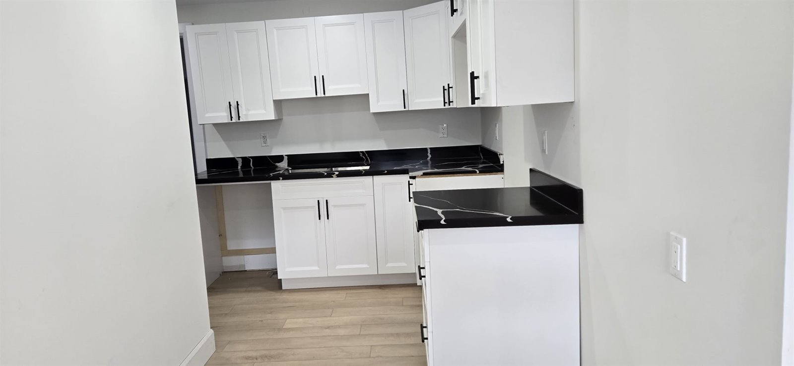 Finished white cabinet wall with under cabinet lighting