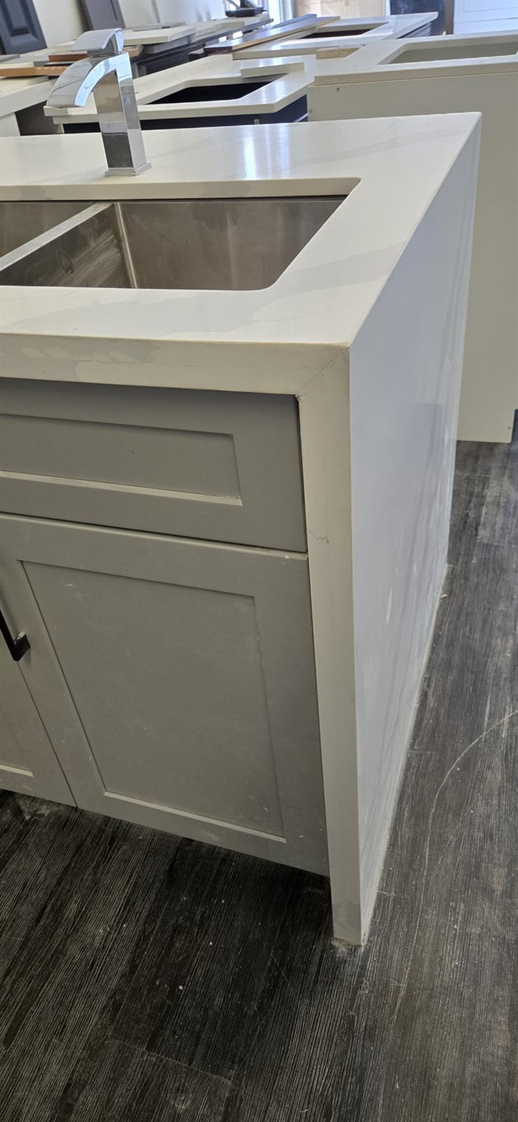 Grey base cabinet detail with dark countertop