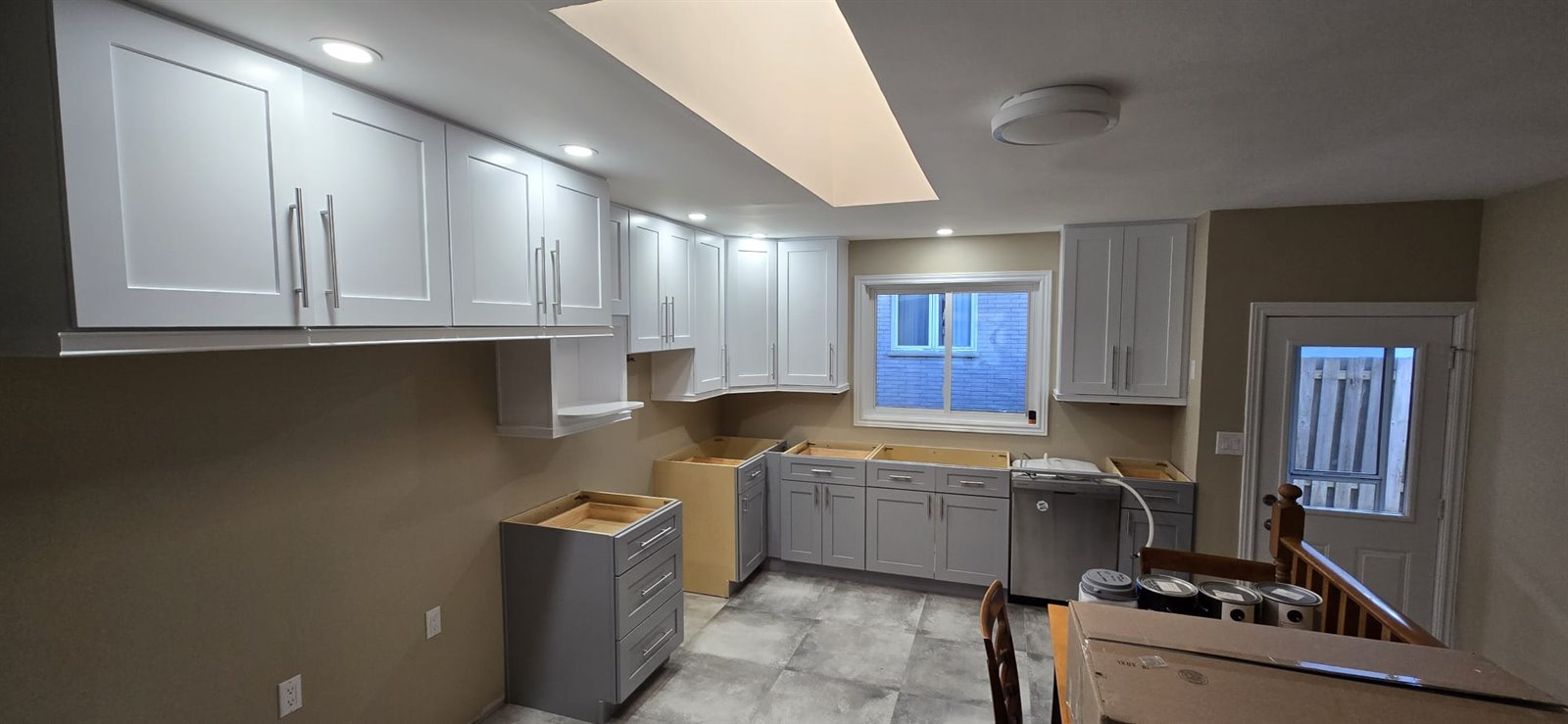 Long kitchen cabinet installation in progress
