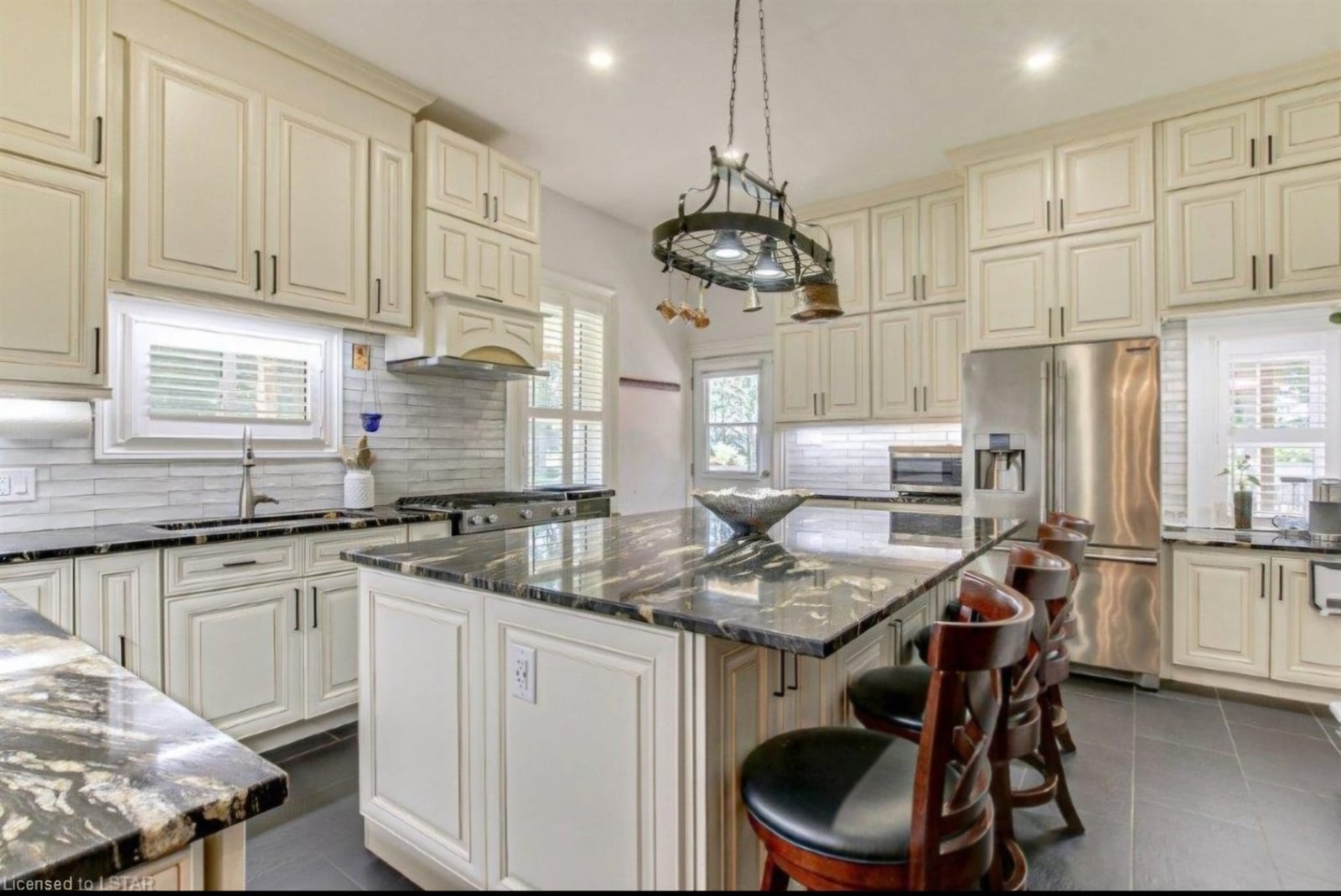 Luxury white kitchen cabinetry with island seating
