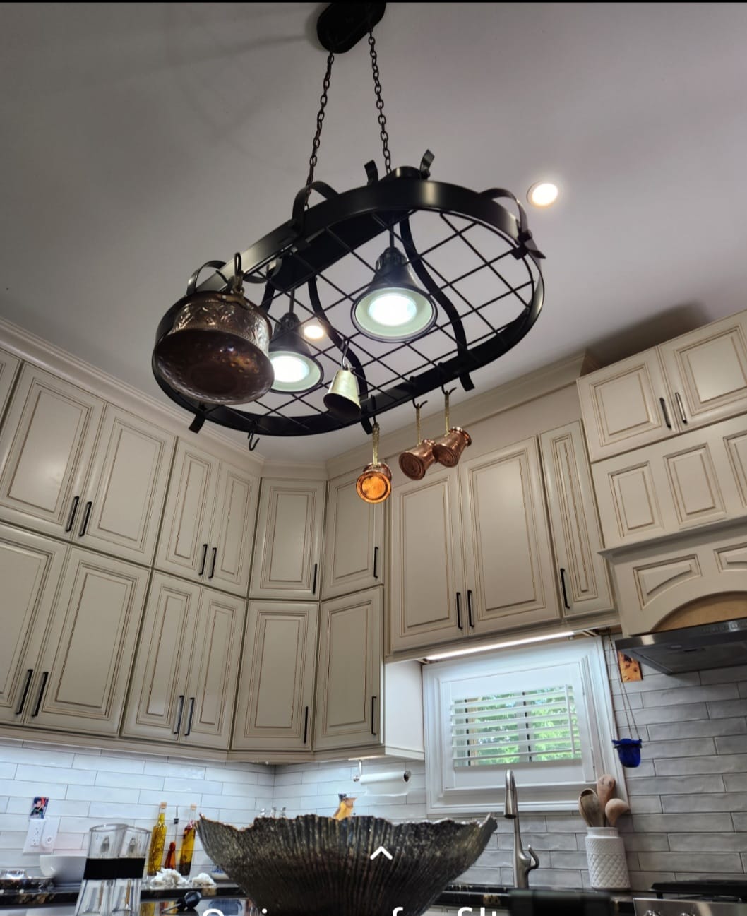 White kitchen cabinets with chandelier lighting